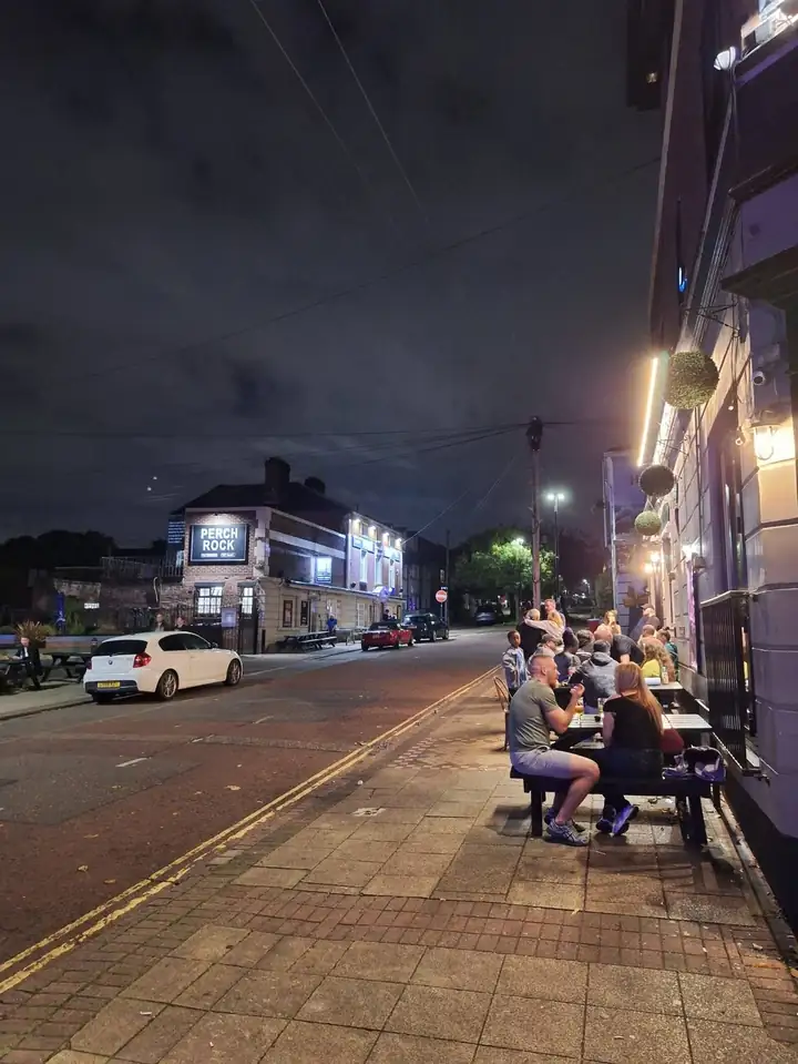 Perch Rock pub and outdoor drinkers in New Brighton at night