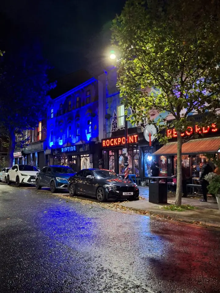 Riptide and Rockpoint Records lit up at night in New Brighton