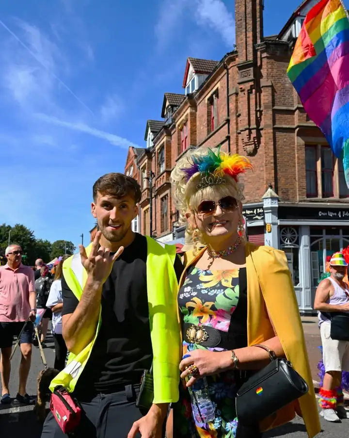A Victoria Security officer in hi-vis at Wirral Pride, alongside a performer